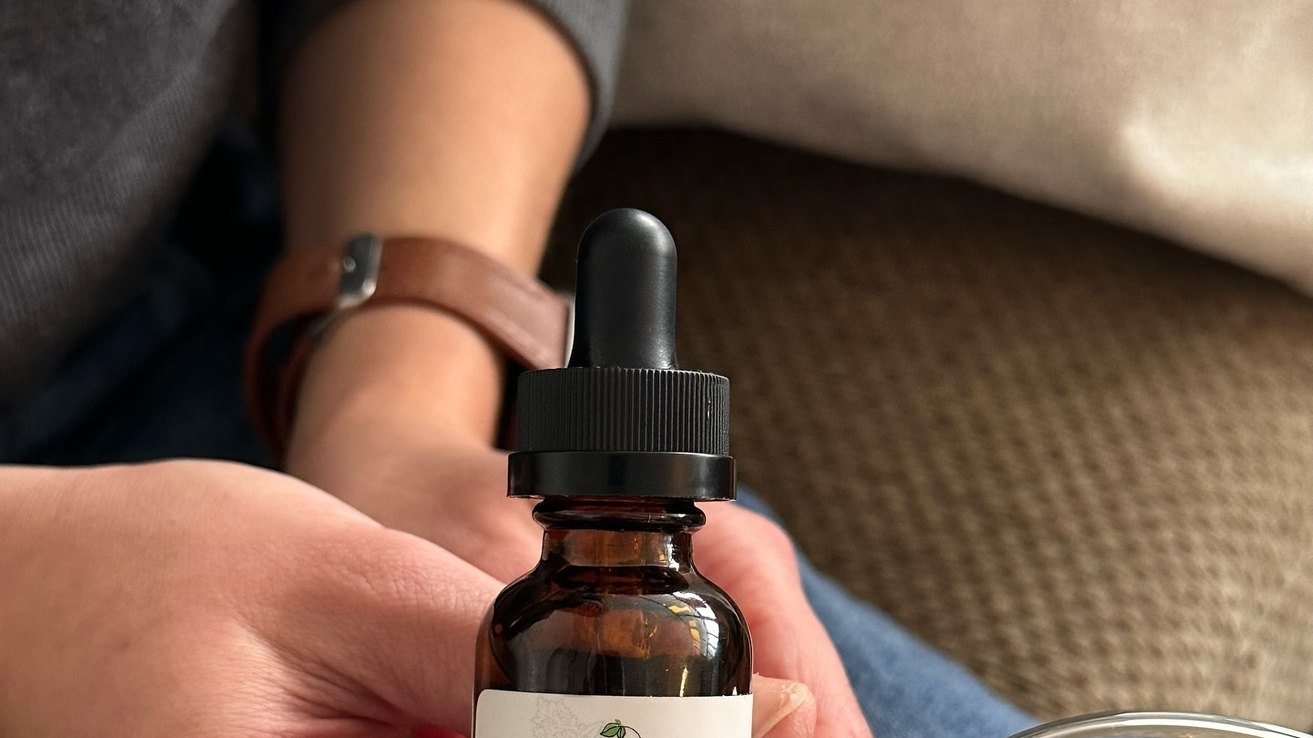 Kurativ CBD Full Spectrum oil bottle outdoors in natural light