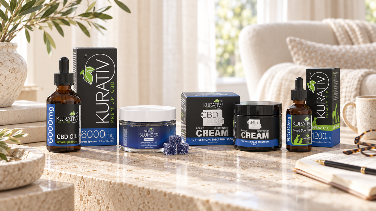 Kurativ Premium CBD broad-spectrum CBD oil, Slumber gummies, CBD + CBG cream and pet oil on a sunlit stone console.